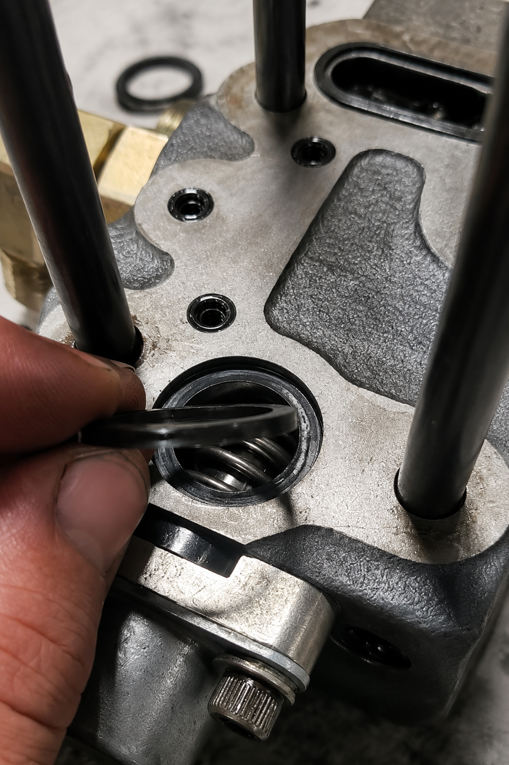 Hand placing a rubber seal into a machined mechanical housing during component repair