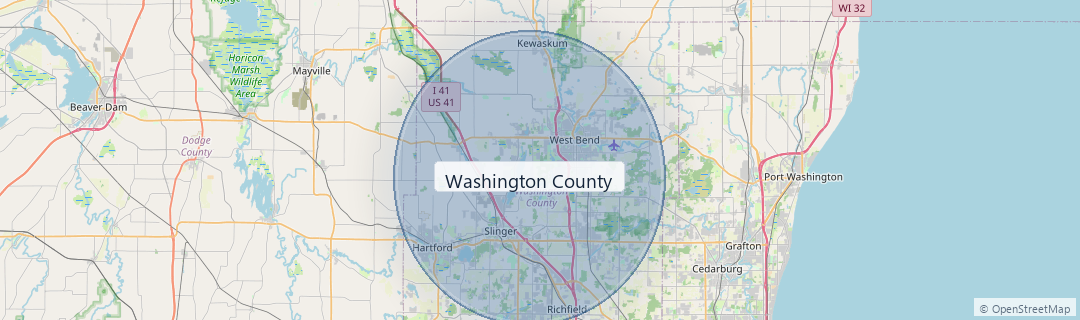 Road map centered on Washington County, Wisconsin, with a soft blue coverage area highlighting the primary service region. Nearby surrounding areas are visible for context. Coverage is arranged by job and scheduling and is not guaranteed for every location.